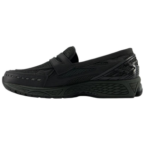Rear three-quarter perspective of the New Balance 1906L Black, emphasizing the textured black finish and supportive heel structure.