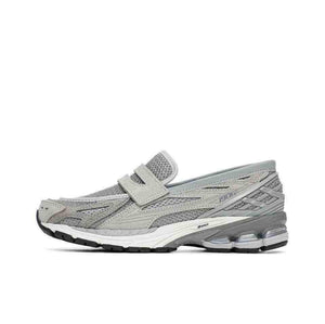 A close-up side perspective of the front portion of the New Balance 1906L grey, detailing the mesh material, synthetic overlays, and the distinctive Nロゴ. Popular choice for new balance 1906l men and women (نيو بالانس 1906L رمادي للنساء والرجال).