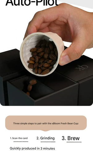 Close-up of coffee beans being poured into the xBloom Studio Enterprise grinder section for automated brewing via Auto-Pilot mode.