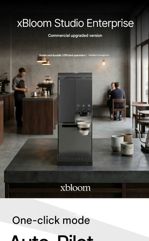 Full view of xBloom Studio Enterprise fully automatic pour-over coffee machine in a professional coffee shop setup with baristas in the background.
