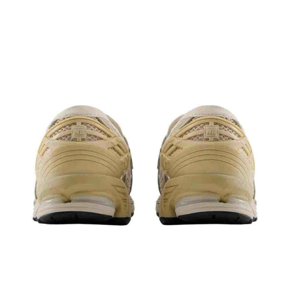 Rear angle view of the New Balance 1906L Beige and Yellow showing the supportive heel cushioning and midsole details.