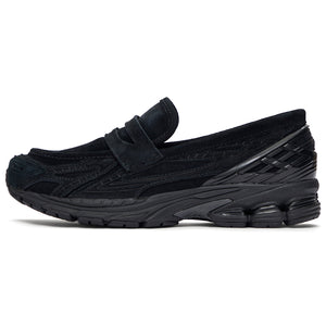 A lateral profile showcasing the New Balance 1906L Triple Black hybrid loafer with its sleek all-black design.