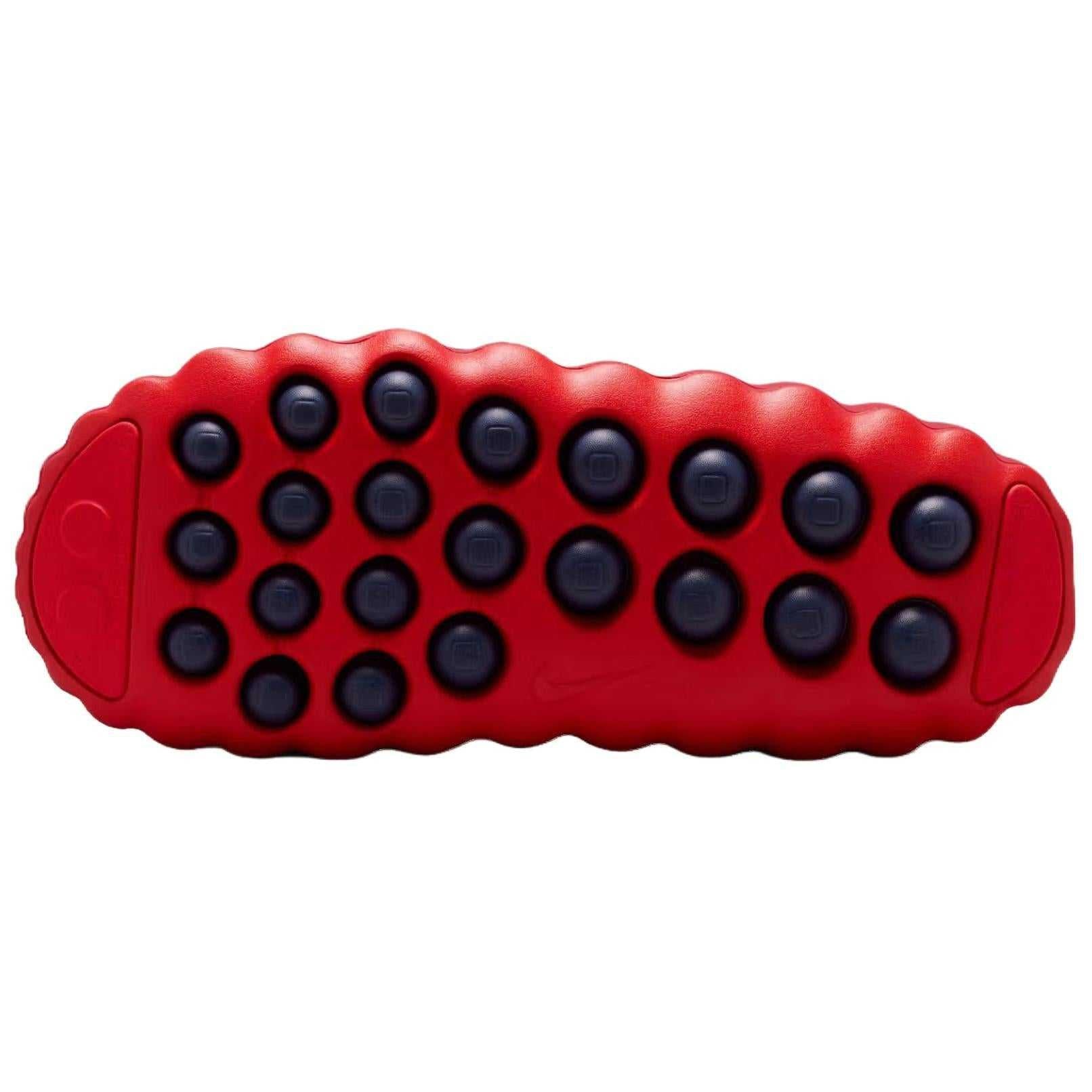 View of the textured bright red outsole of the Nike Mind 001 mule, featuring the distinct blue dotted sensory-feedback nodes.