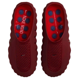 Top-down perspective of a pair of Nike Mind 001 deep red mules, displaying the footbeds with their blue pressure-point design and 'NIKE MIND' branding.