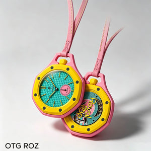 Two yellow and hot pink Otg Roz bioceramic mechanical watches with matching leather cords on a gray background.